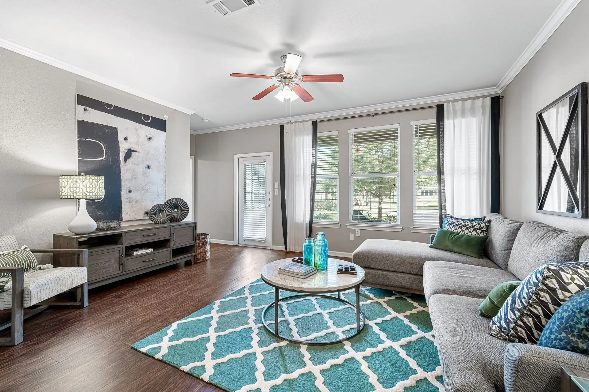 Stylish living room with a sectional sofa, coffee table, and abstract art.