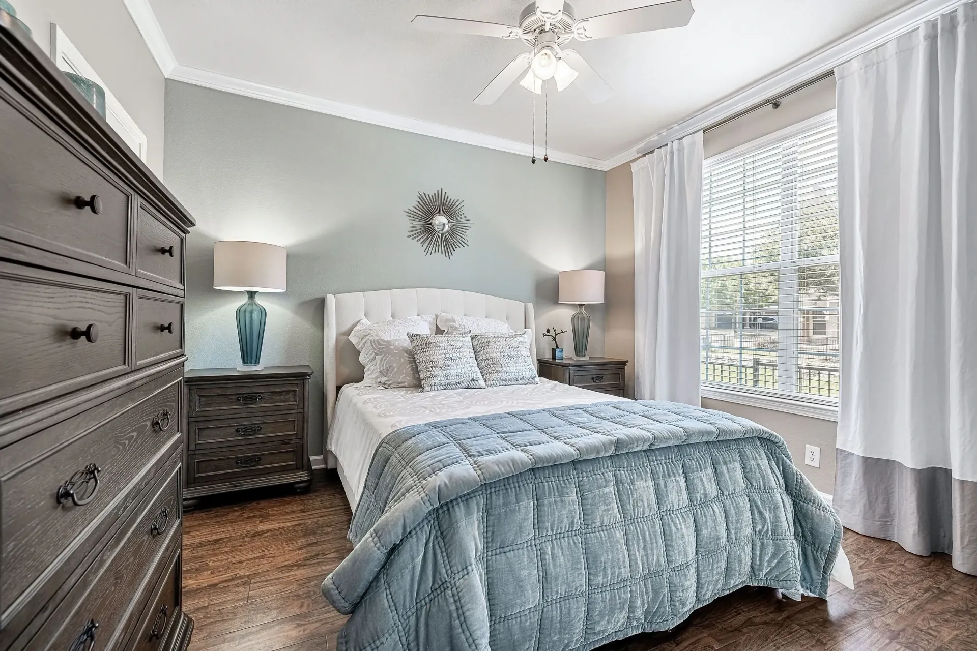 Primary bedroom with a king-sized bed, dresser, and nightstands.
