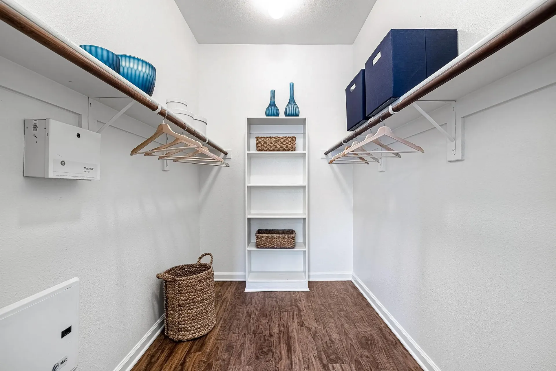 Walk-in closet with shelving and hanging rods