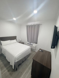 A hotel room with two beds and a lamp