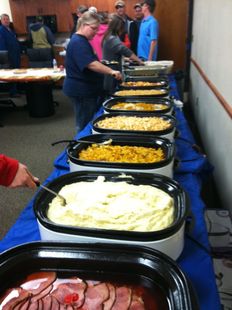 A buffet table with a variety of food on it