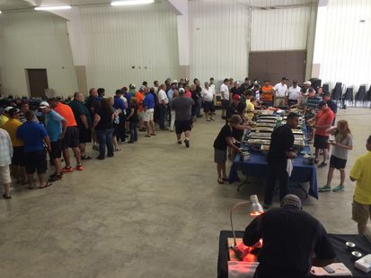 A large group of people are gathered in a large room