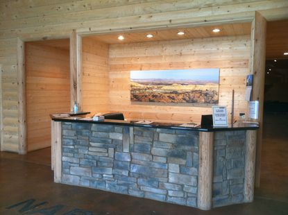 A stone counter with a painting on the wall above it