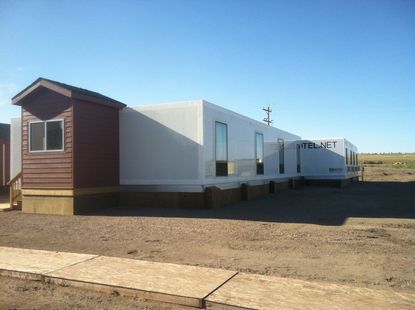 A row of mobile homes are parked next to each other