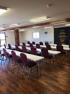 A large room with tables and chairs in it