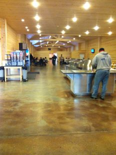 A man standing at a counter in a restaurant