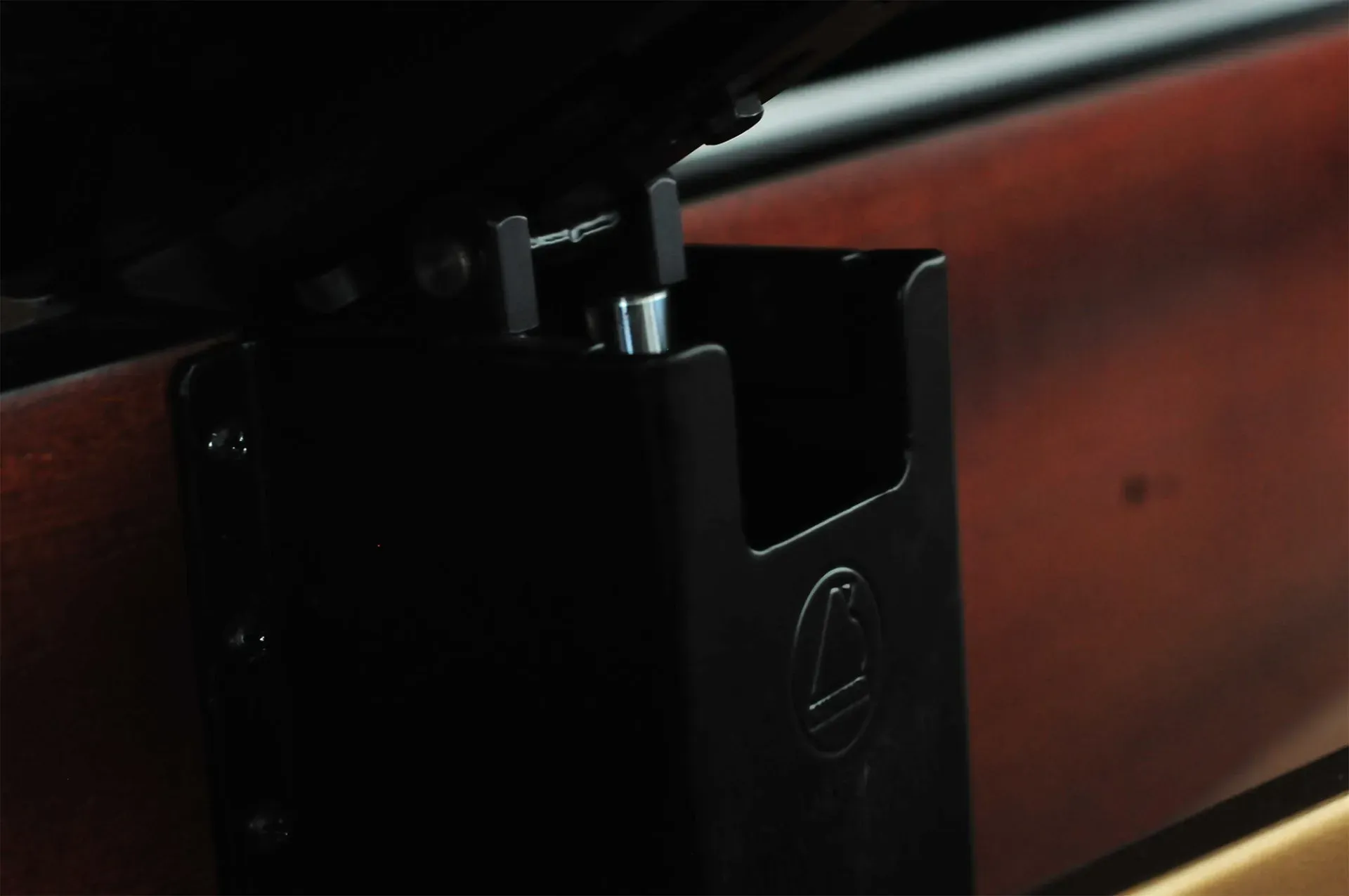 A close up of a piece of wood with a metal holder that says gp on it
