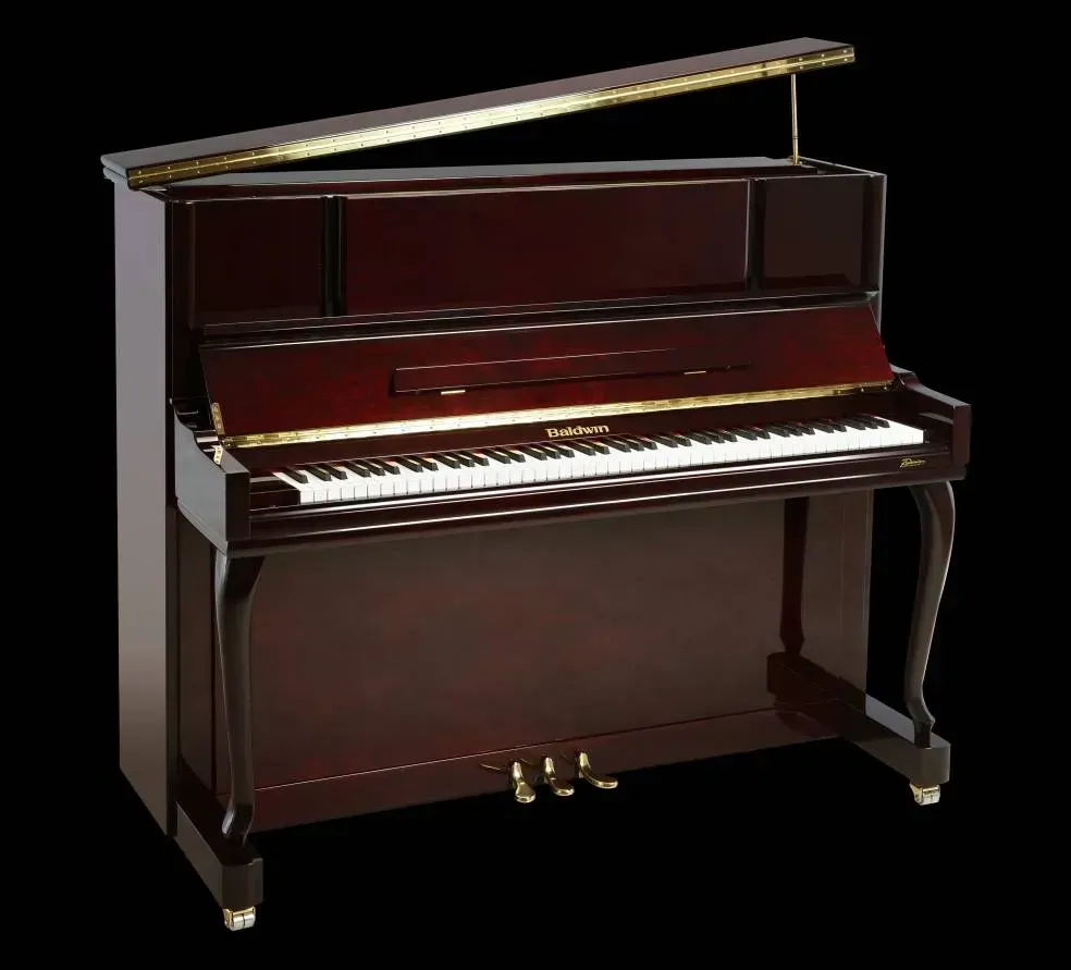A piano with the lid open on a black background