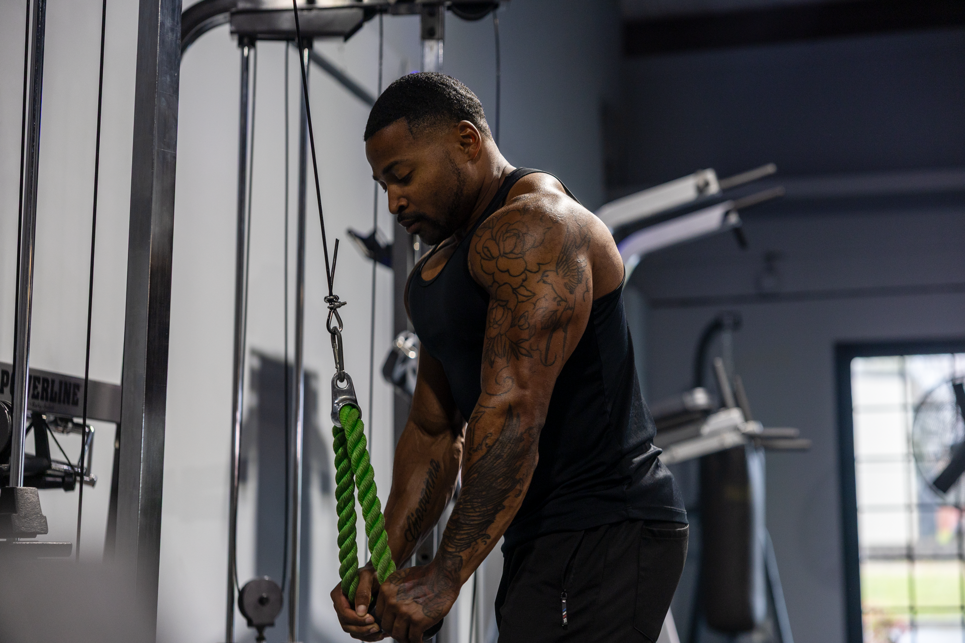 Trey Johnson, Owner of 360 Image Fitness in Watkinsville, doing a tricep exercise with gym equipment at gym in Watkinsville.