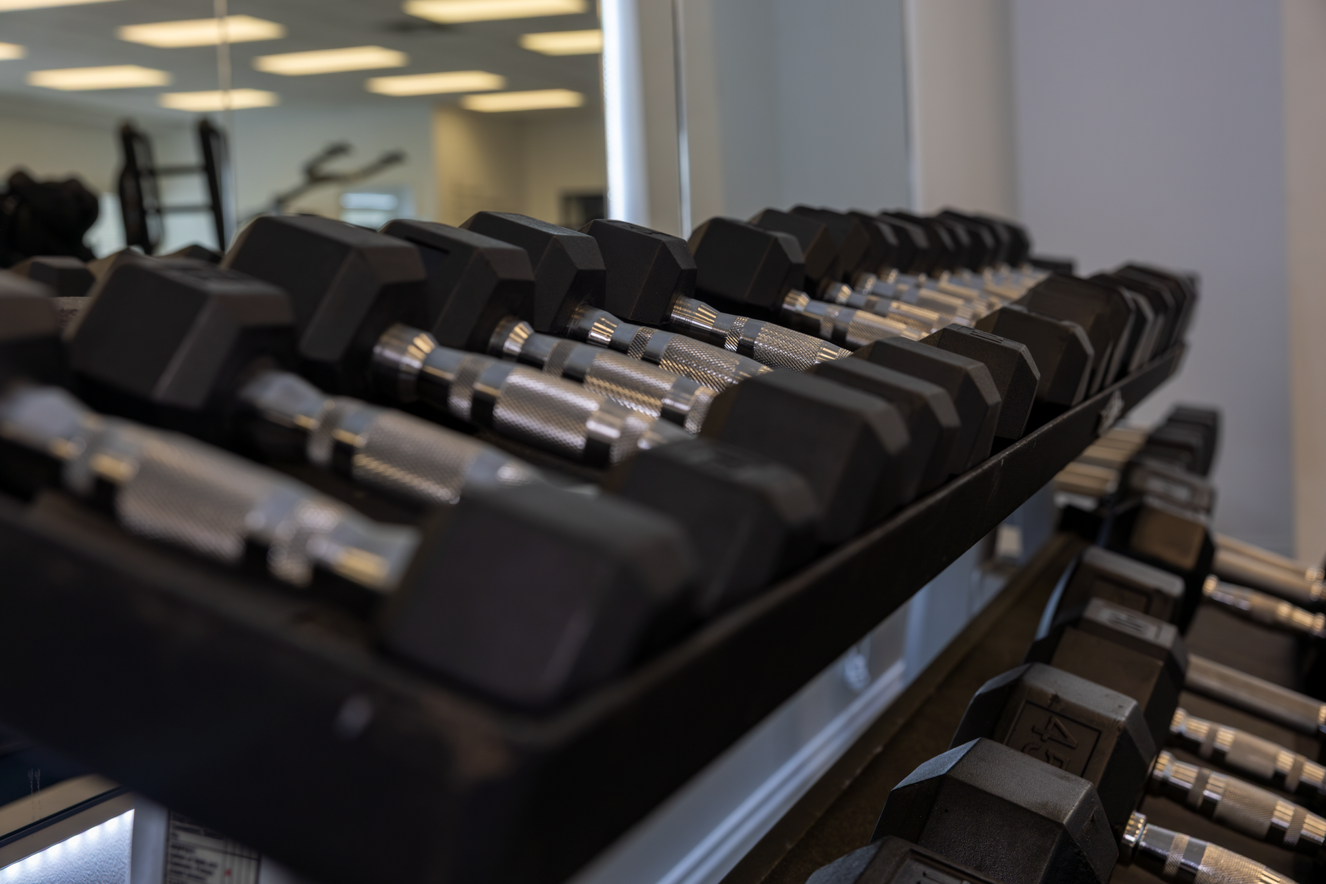 black and silver dumbbells on a dumbbell rack at 360 image fitness gym in watkinsville, ga