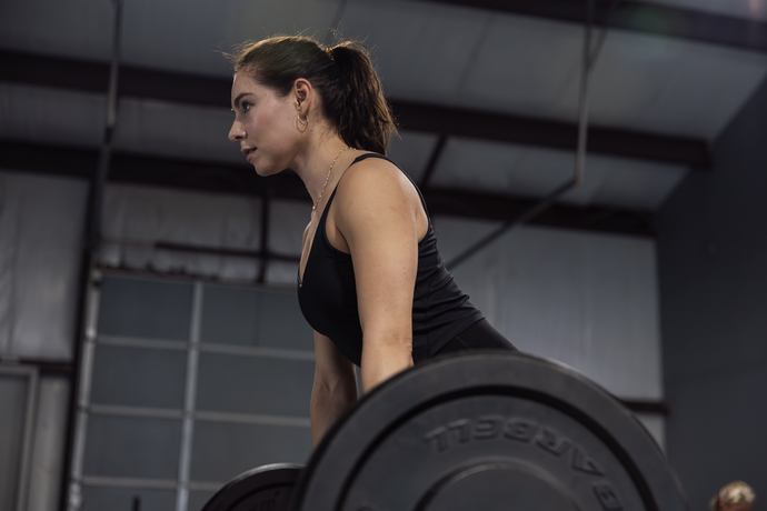 360 image fitness personal training female, brown haired client doing squat and lift strength exercises wearing gym clothes