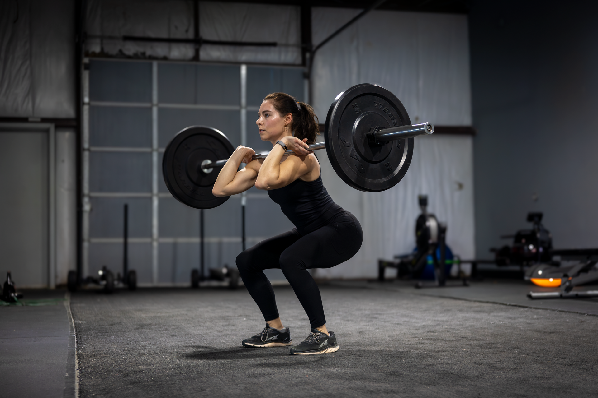 360 image fitness personal training female, brown haired client doing squat and lift strength exercises wearing gym clothes