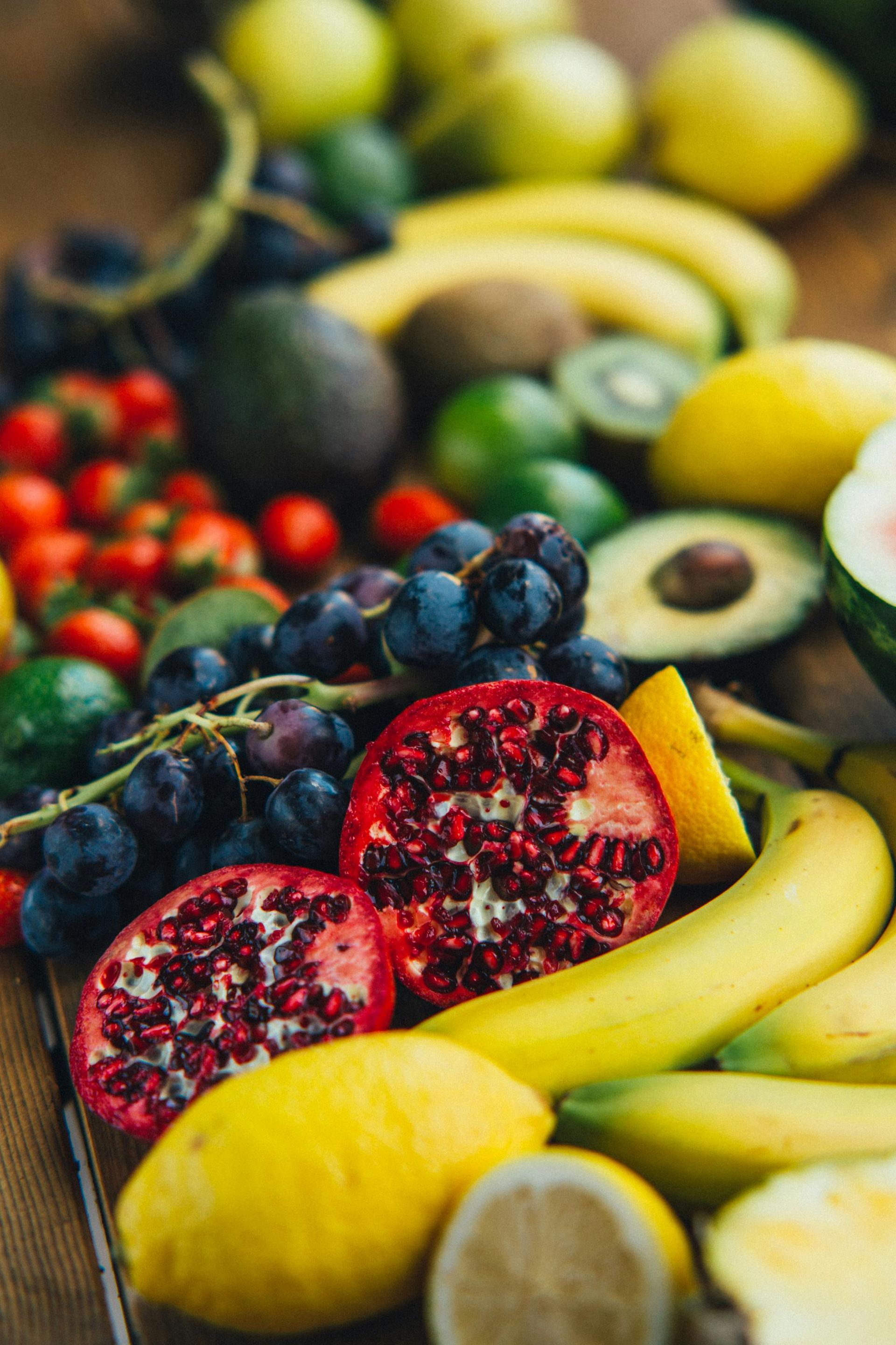 Assorted fresh fruits including bananas, avocados, pomegranates, lemons, and berries arranged on display for 360 image gym
