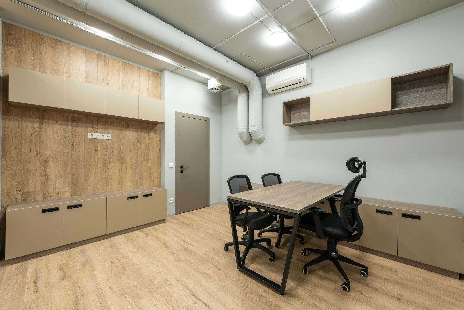 Office showing an AC system on the wall.