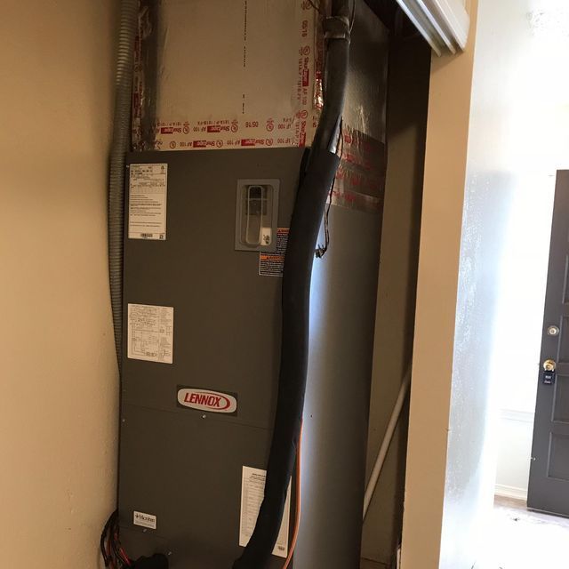 furnace is sitting in a room next to a door.