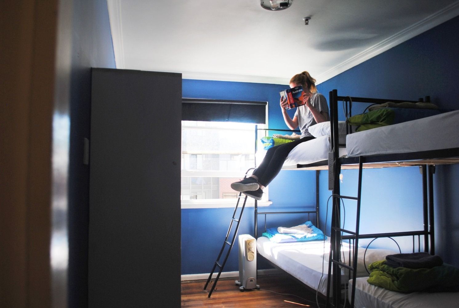 A female backpacker sitting in Pint on Punt's 6bed female dorm