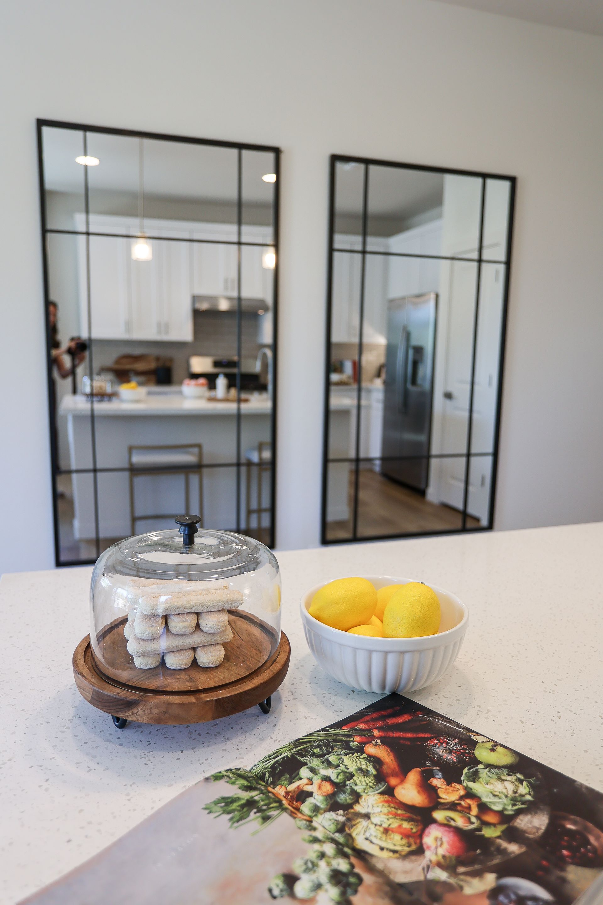 Kitchen with glass doors, a countertop, and bowls of snacks and fruit in the foreground.