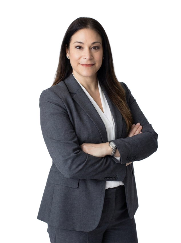 Woman in a formal attire standing confidently.
