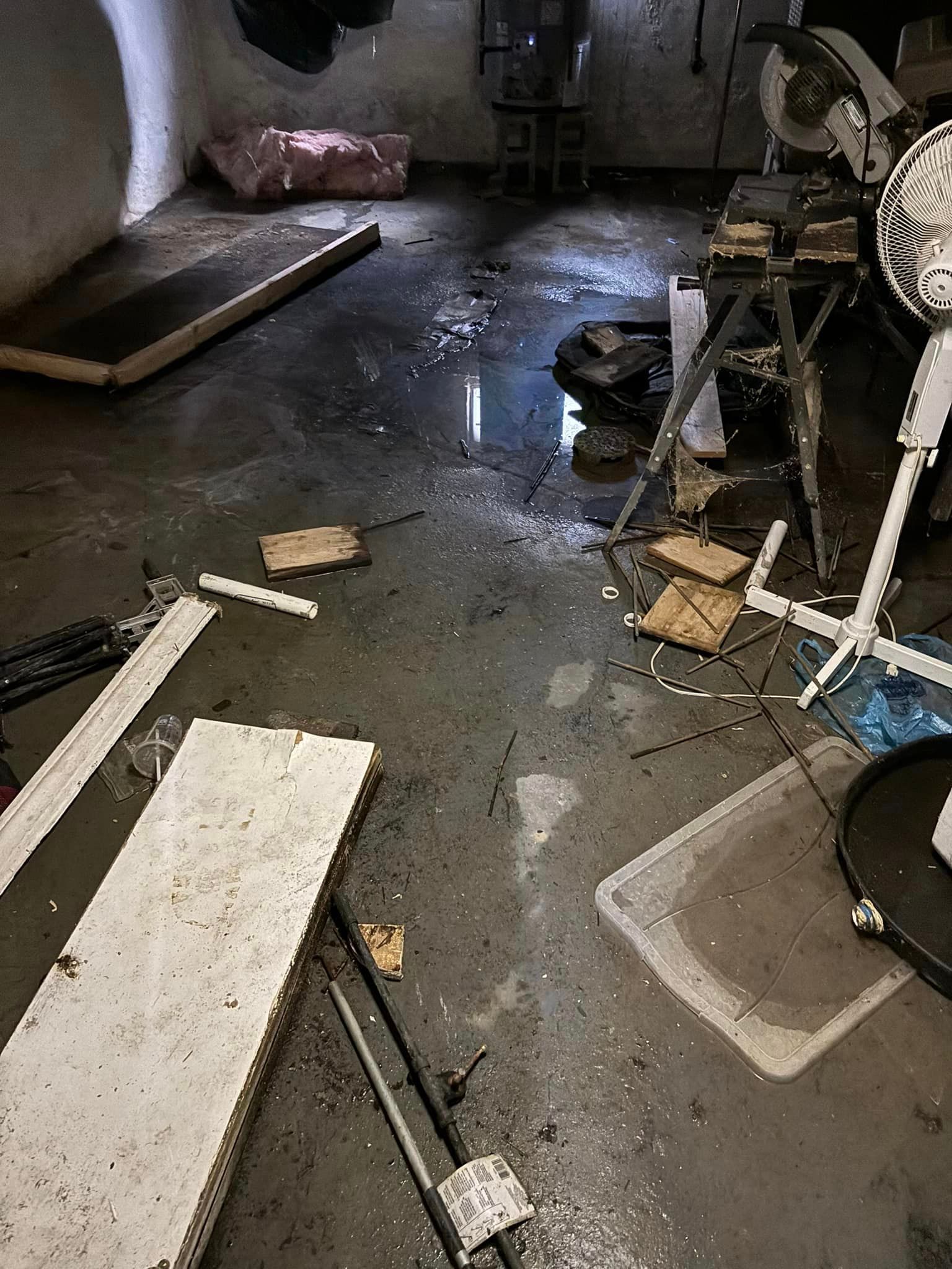 A messy room with a lot of junk on the floor.