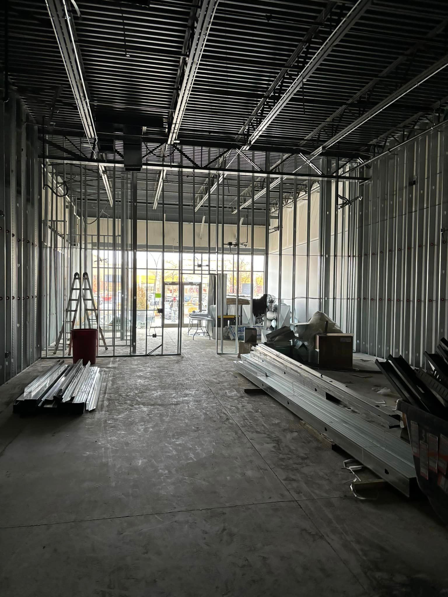 The inside of a building under construction with a lot of metal.