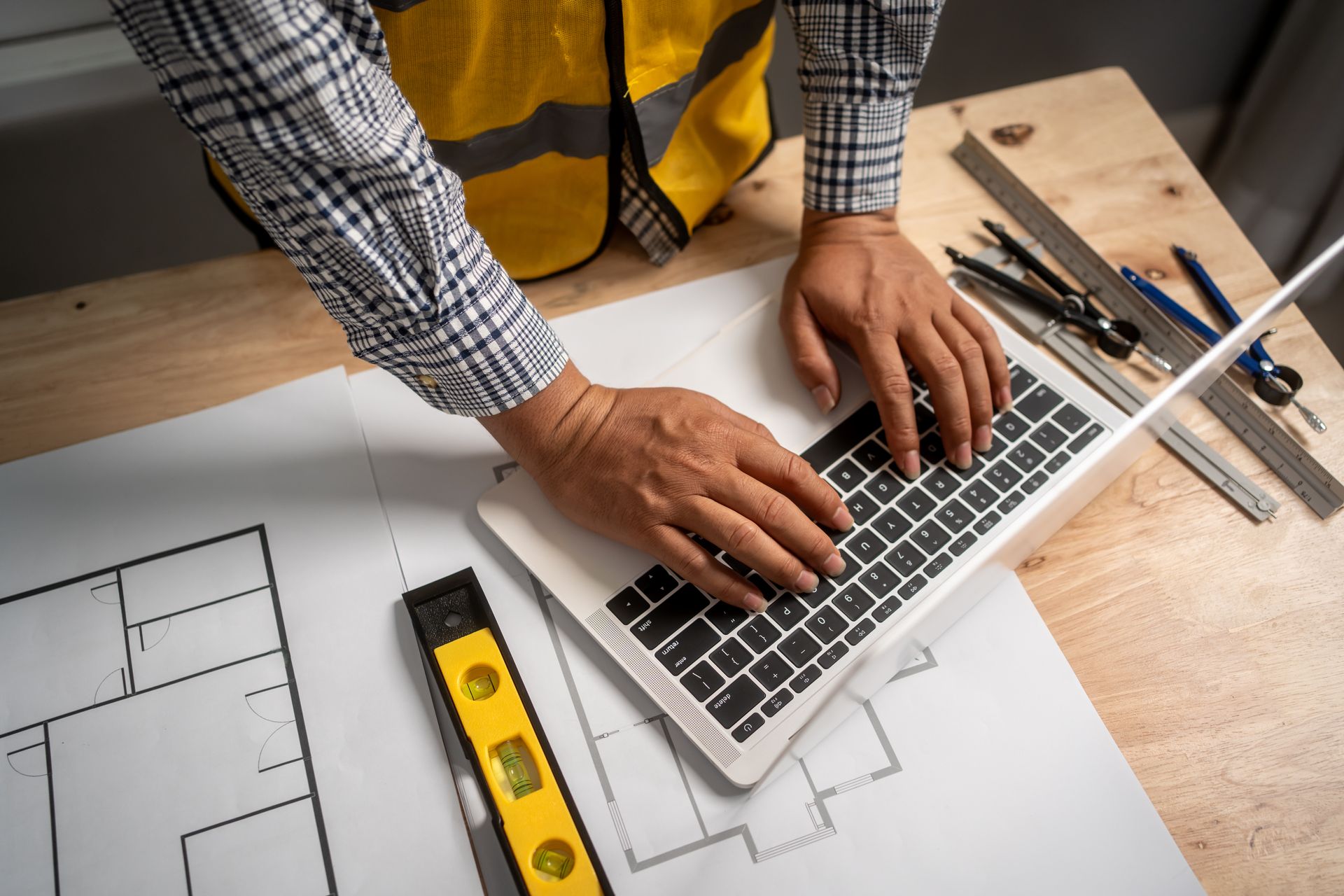 General contractor reviewing project plans with a subcontractor on-site