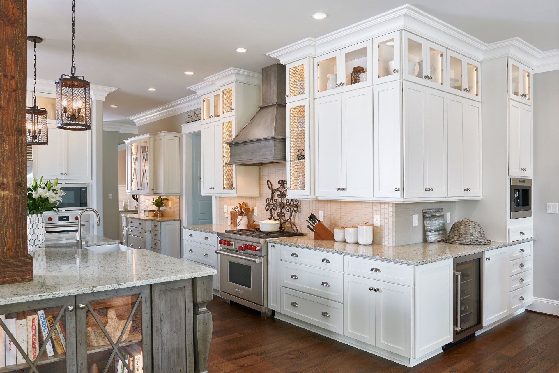 Bright white kitchen with large island, granite countertops, stainless appliances, and pendant lighting