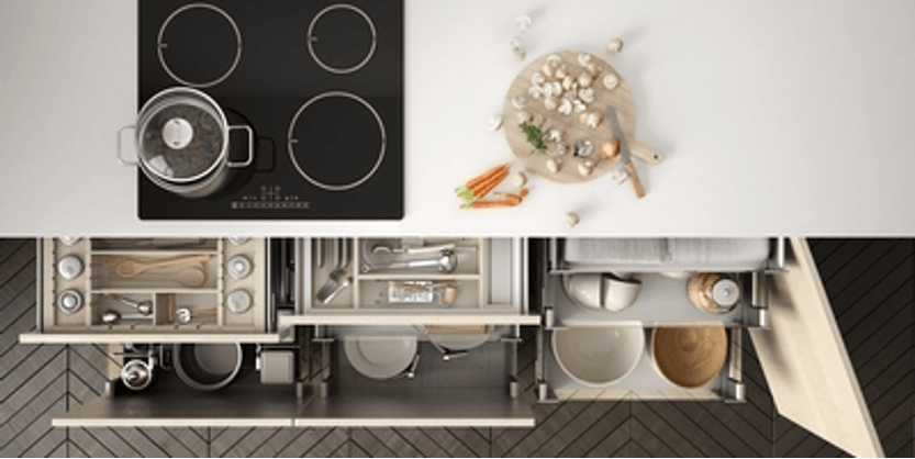 Top-down kitchen floor plan with black stove, countertop storage, and a dining table set with a white centerpiece