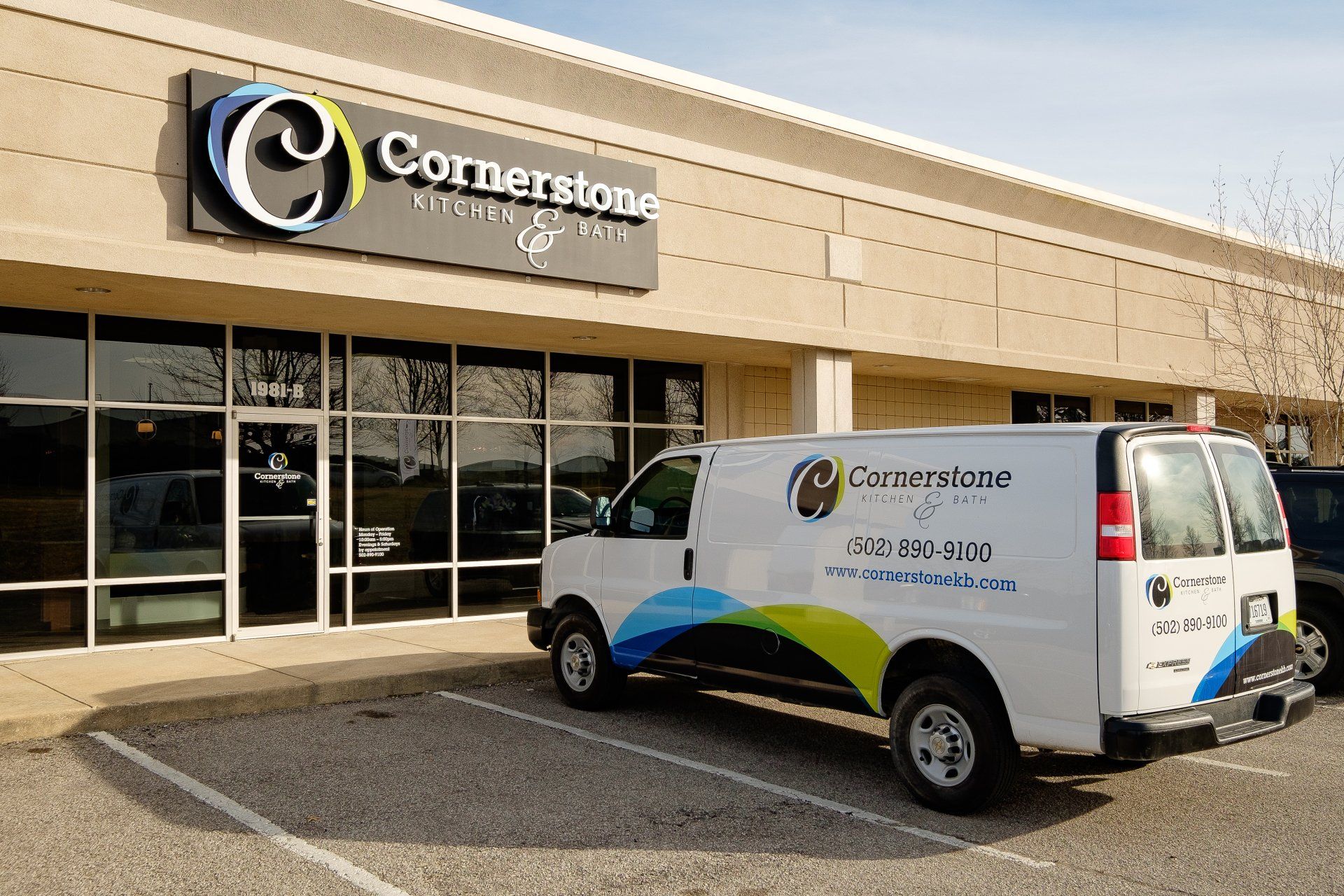 Cornerstone office storefront with a white company van parked outside in front of the building.