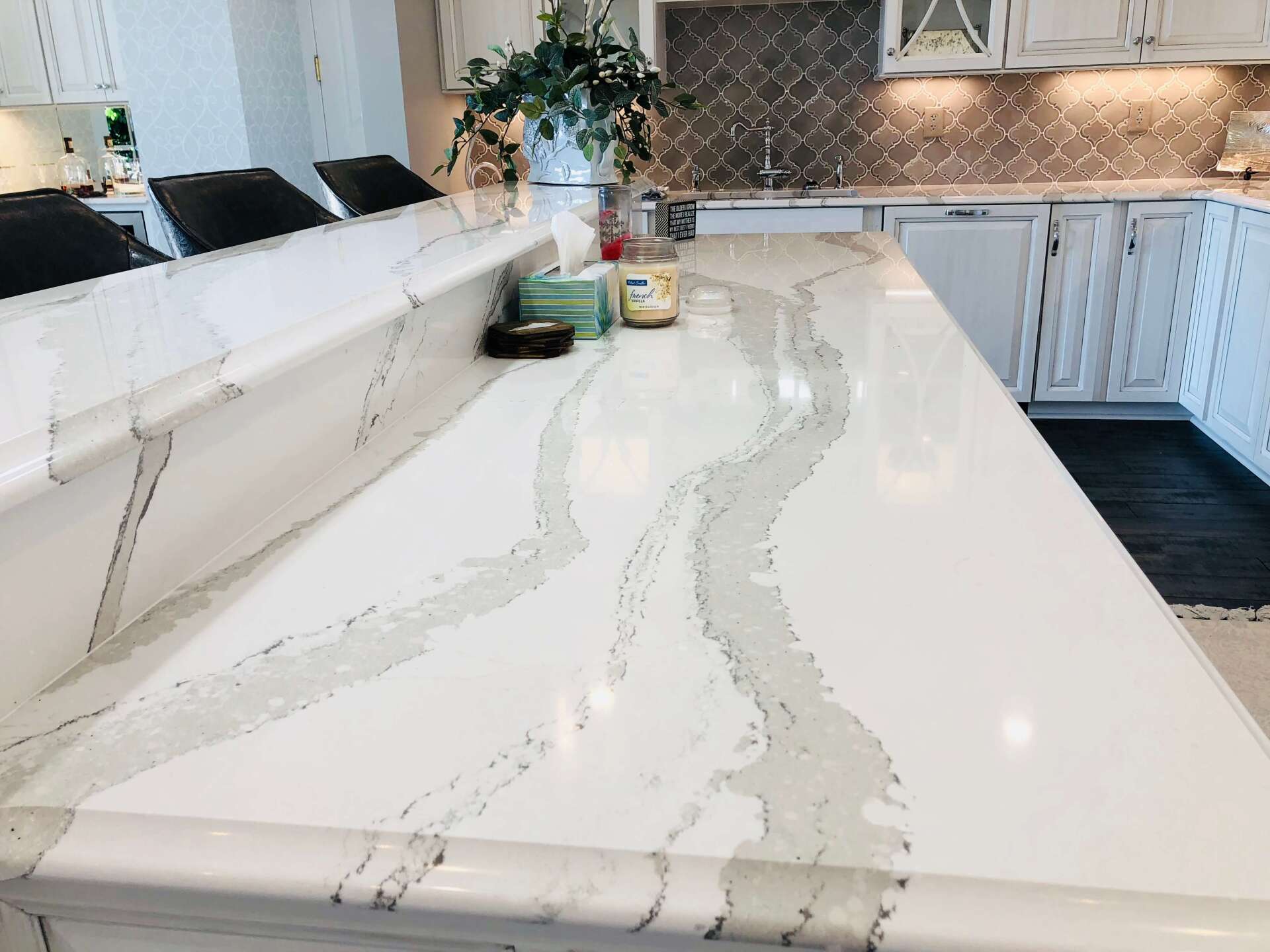 Modern kitchen with a white quartz island countertop and light wood cabinets