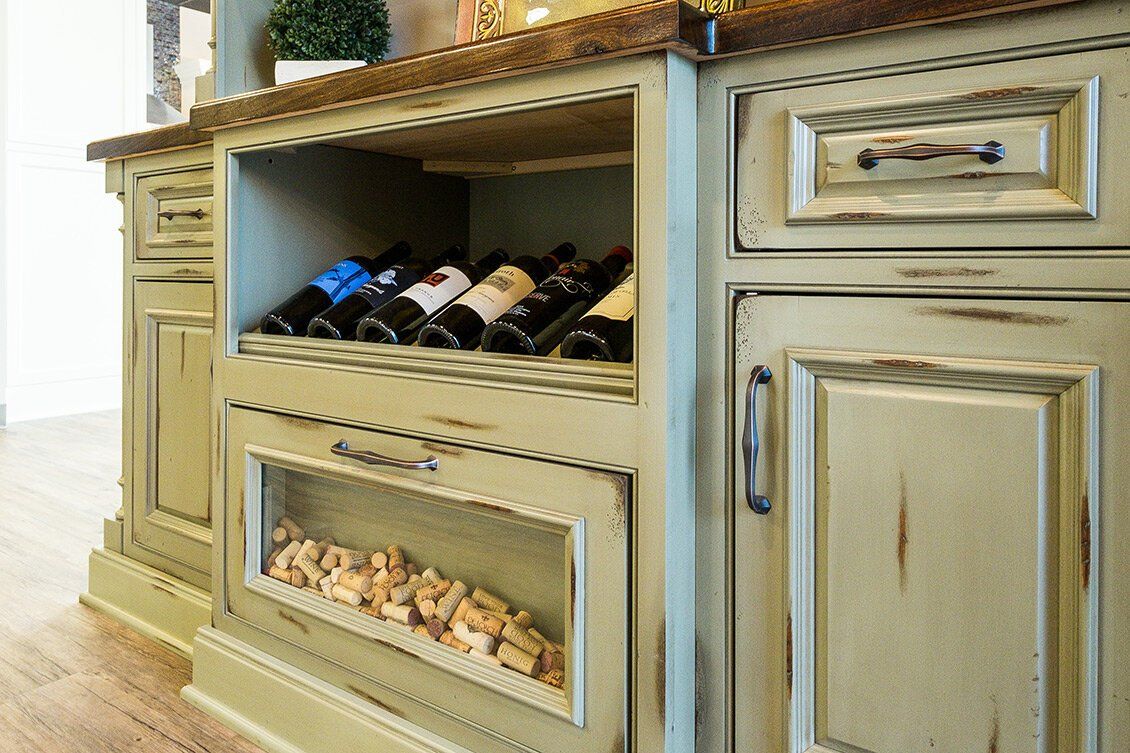 Built-in wine rack and cabinet with bottles displayed on a kitchen island