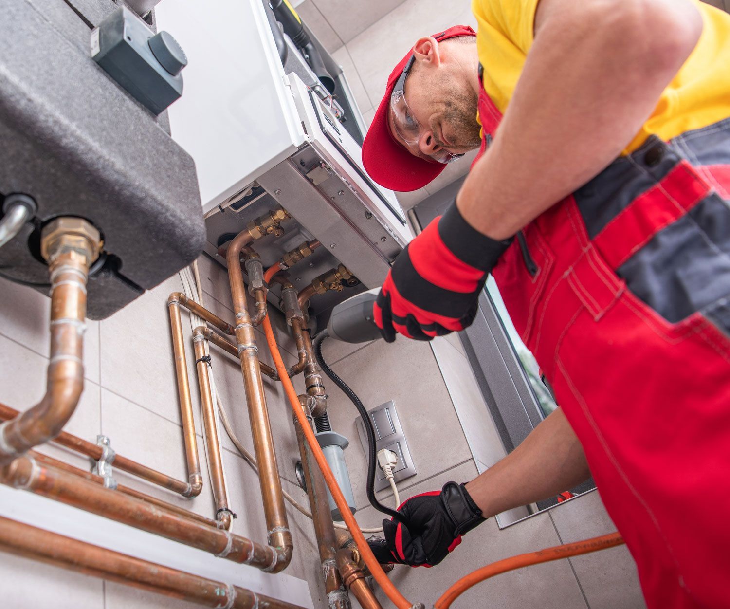 Professional Gas Heating Technician with Natural Gas Detector Device Looking For Potential Leaks Inside the Heating Furnace System