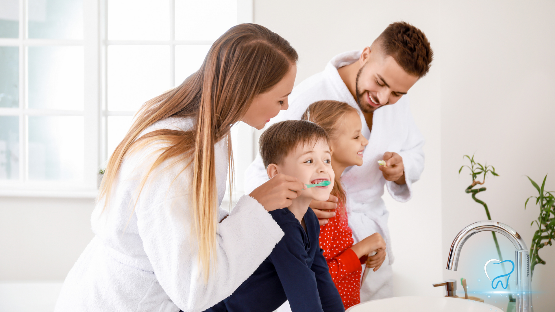 Family brushing teeth together at a bathroom sink, smiling in bright natural light.