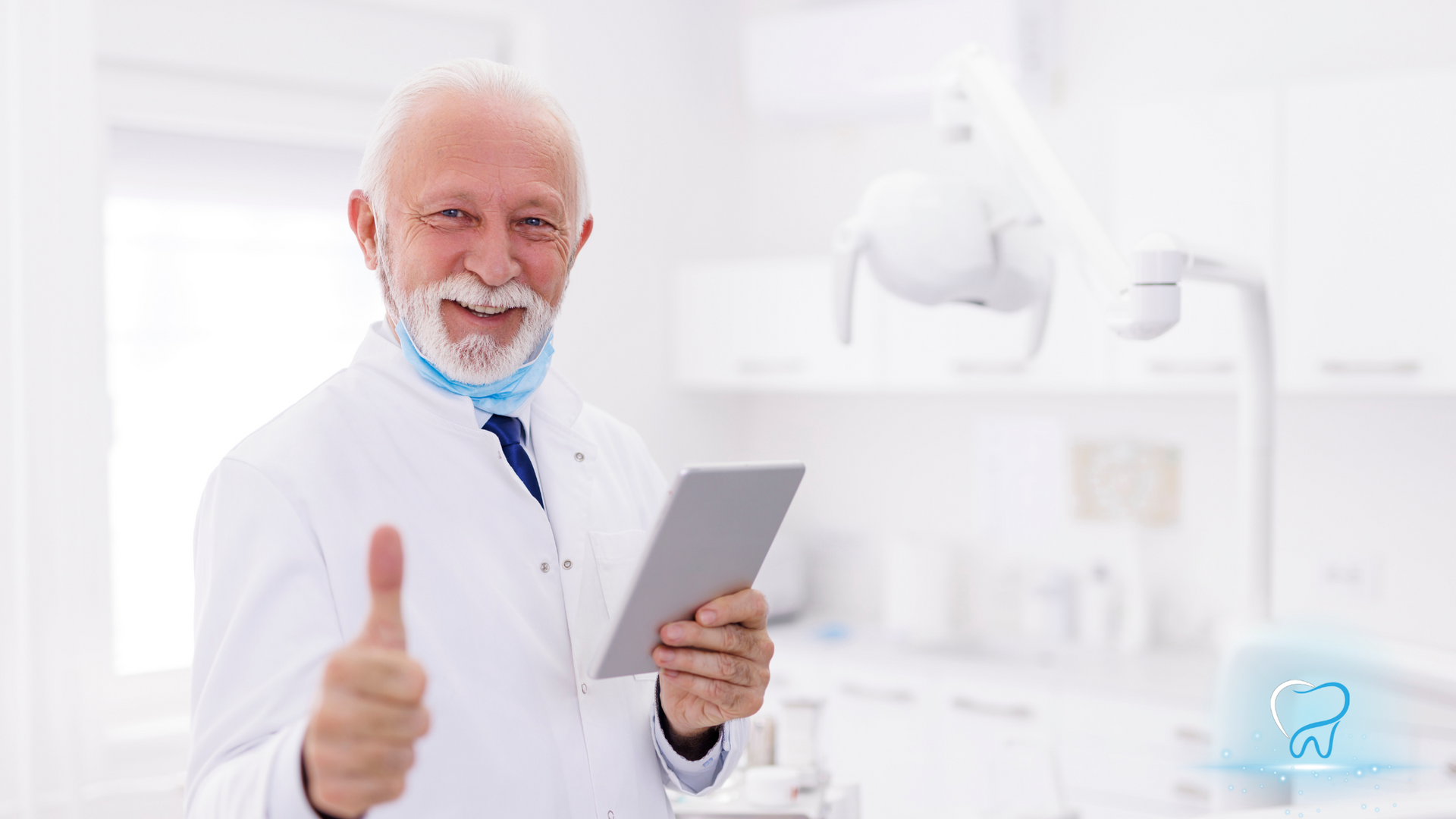 Smiling doctor in white coat holding a tablet and giving a thumbs-up in a bright clinic.