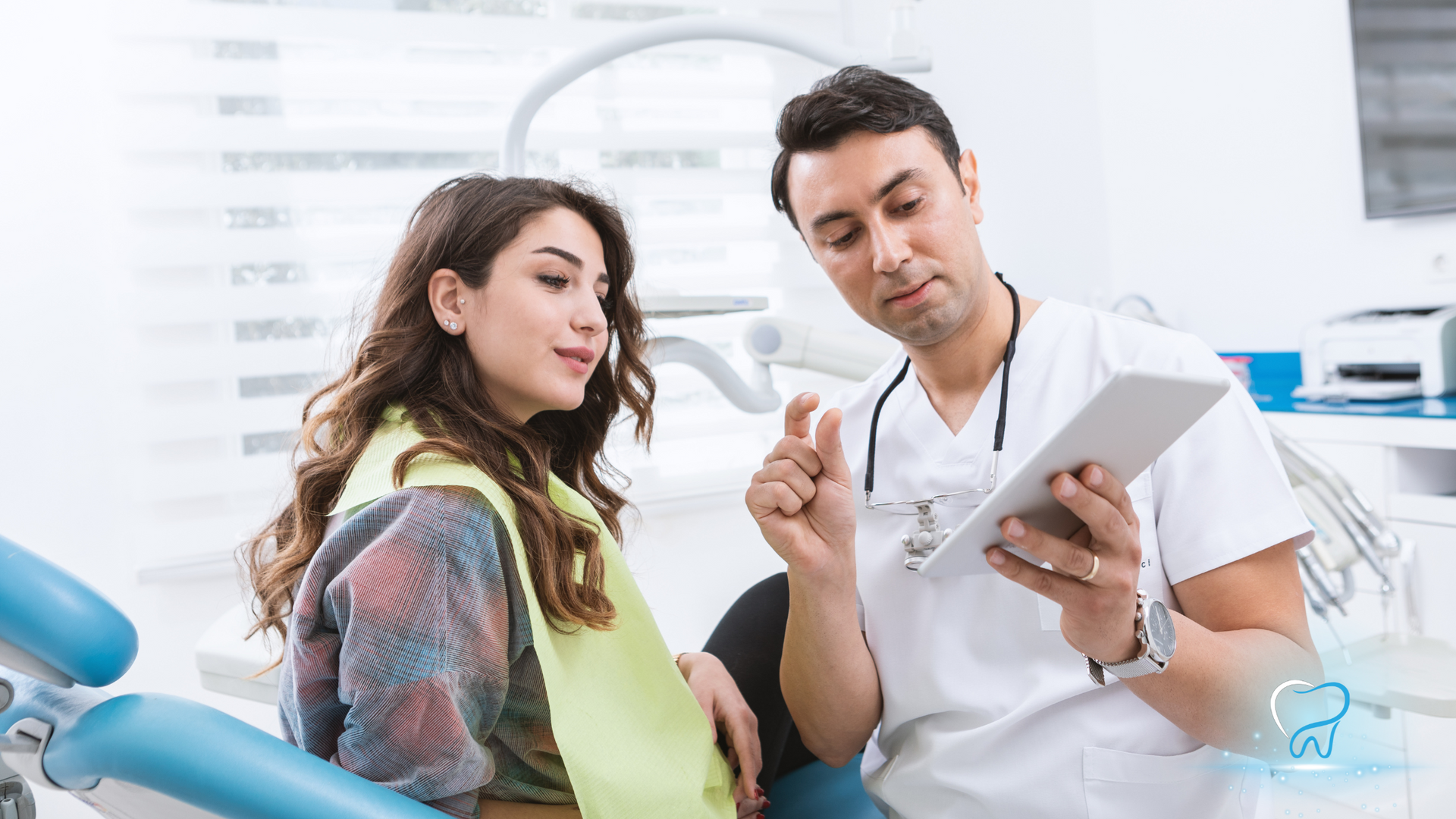 Dentist showing a patient a treatment plan on a tablet in a bright clinic
