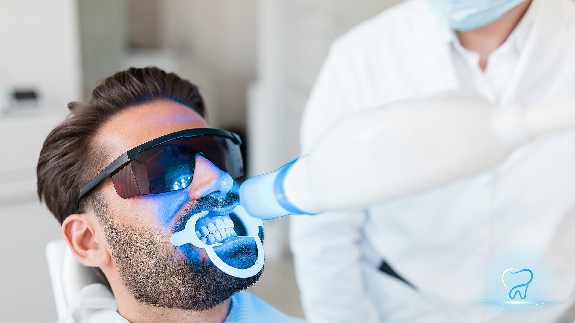 Teeth whitening procedure with blue light in a dental clinic