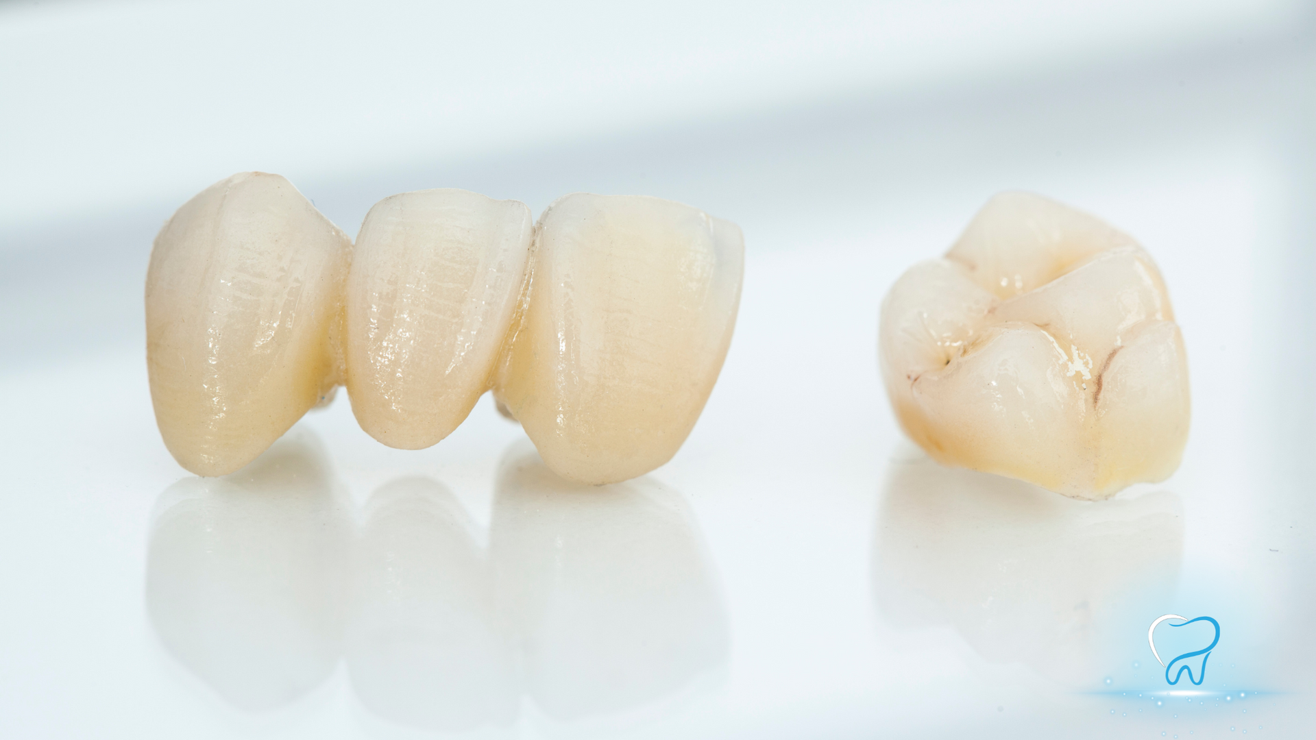 Three beige dental crowns on white, with one crown shown separately, top view
