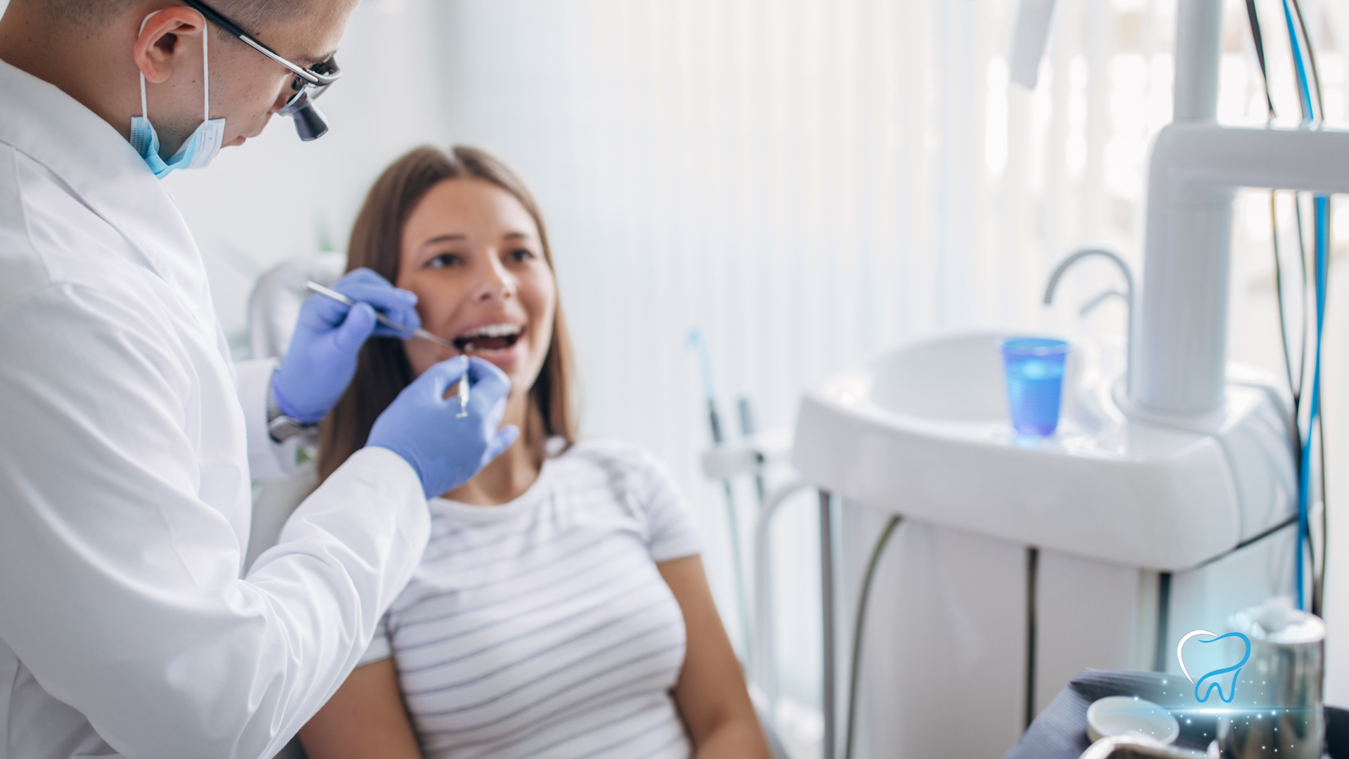 Dentist examining a patient in a bright dental clinic with tools and tray nearby