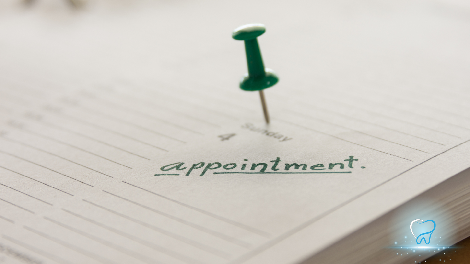 Green pushpin marking “appointment” on a lined planner page