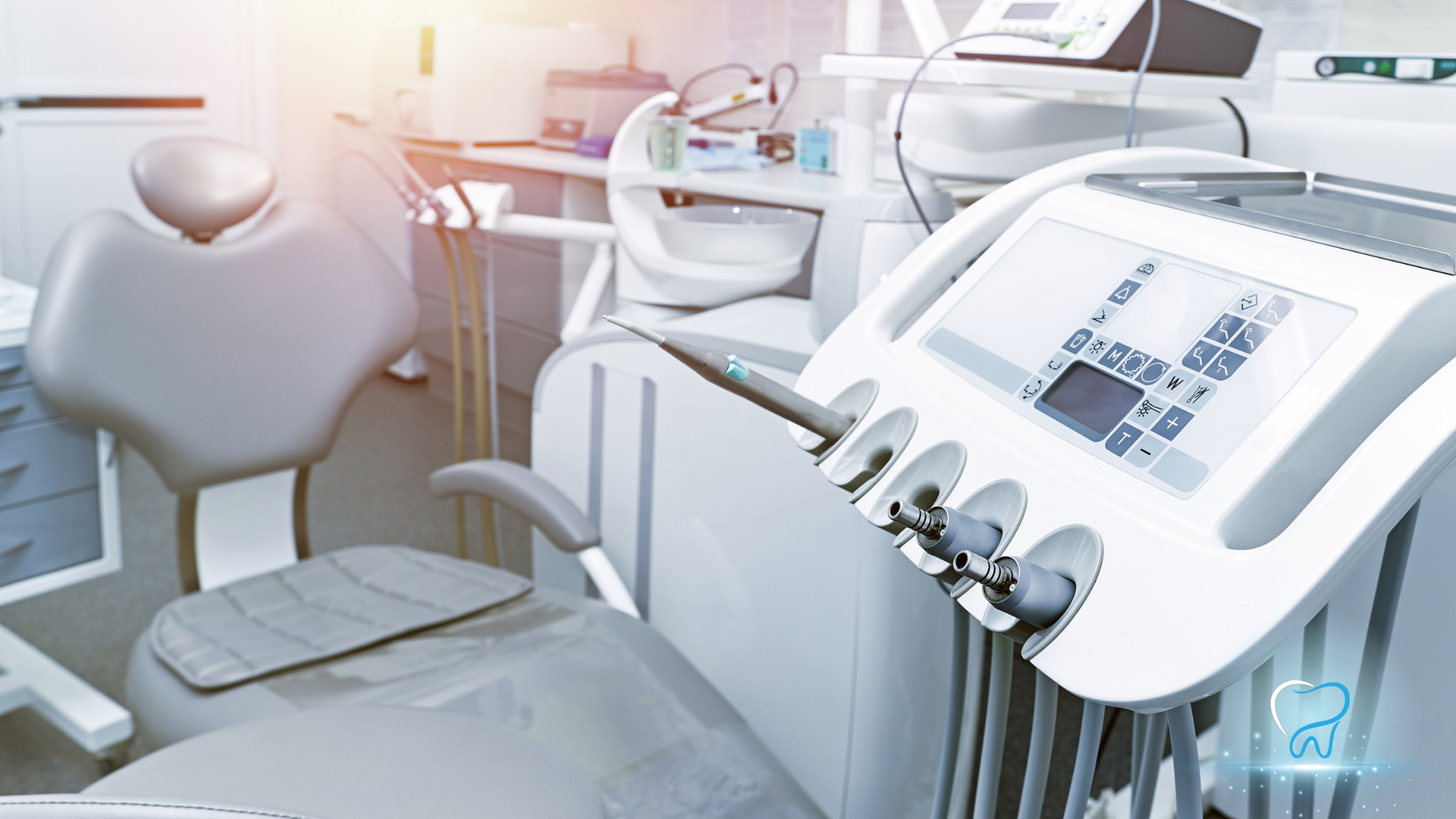 Bright dental clinic with modern white equipment, chair, and control panels in a clean, sunlit room