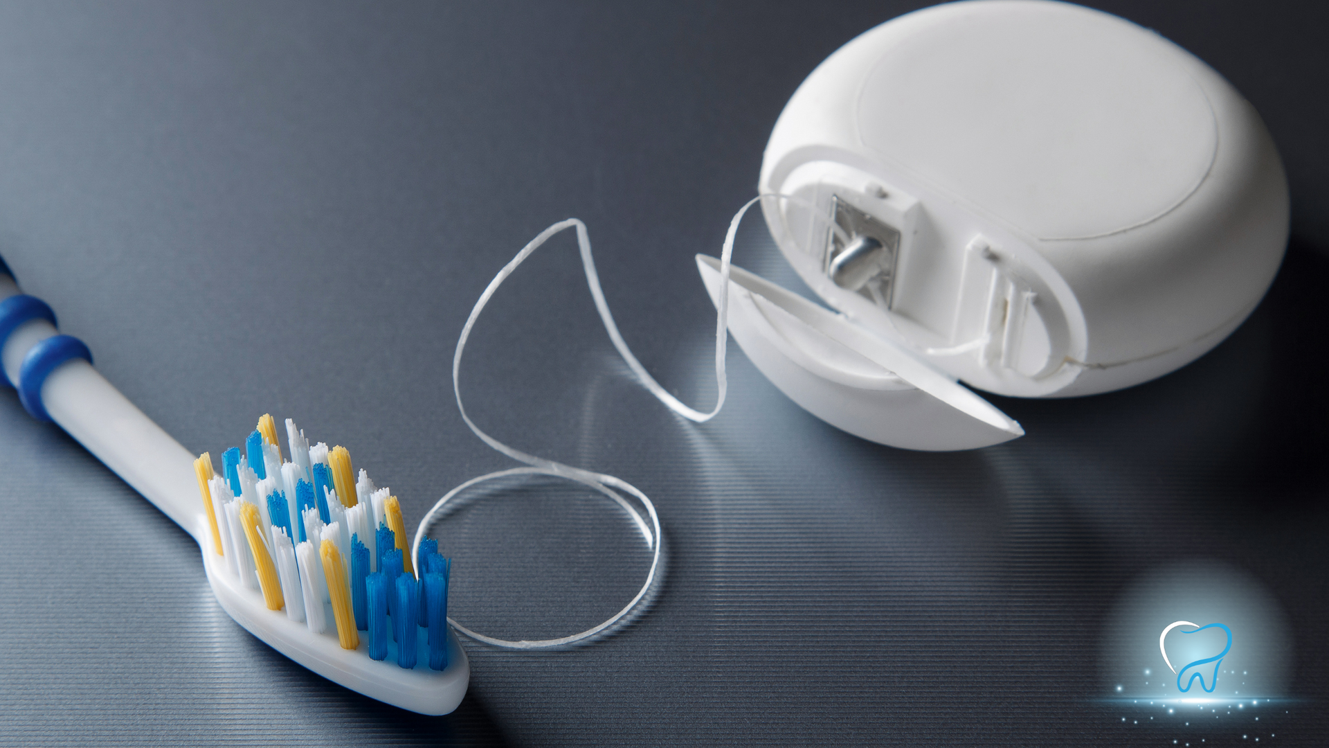 Electric toothbrush with white charging case and detached brush head on a dark surface.