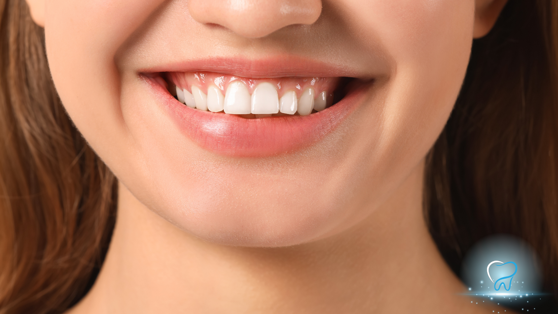 Close-up of a smiling mouth with white teeth and pink lips