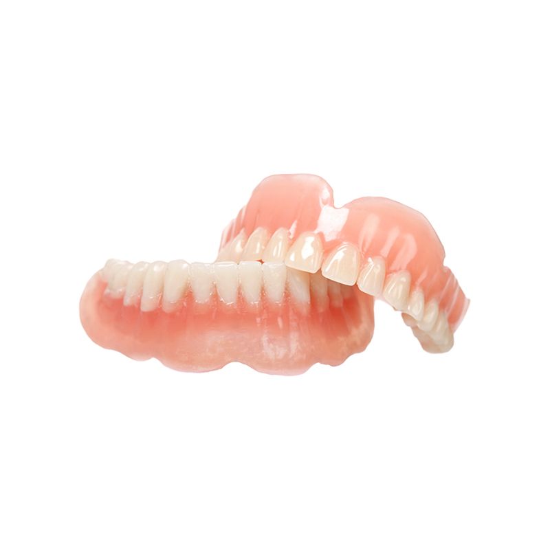 Two pink-and-white gum-colored dentures on a white background