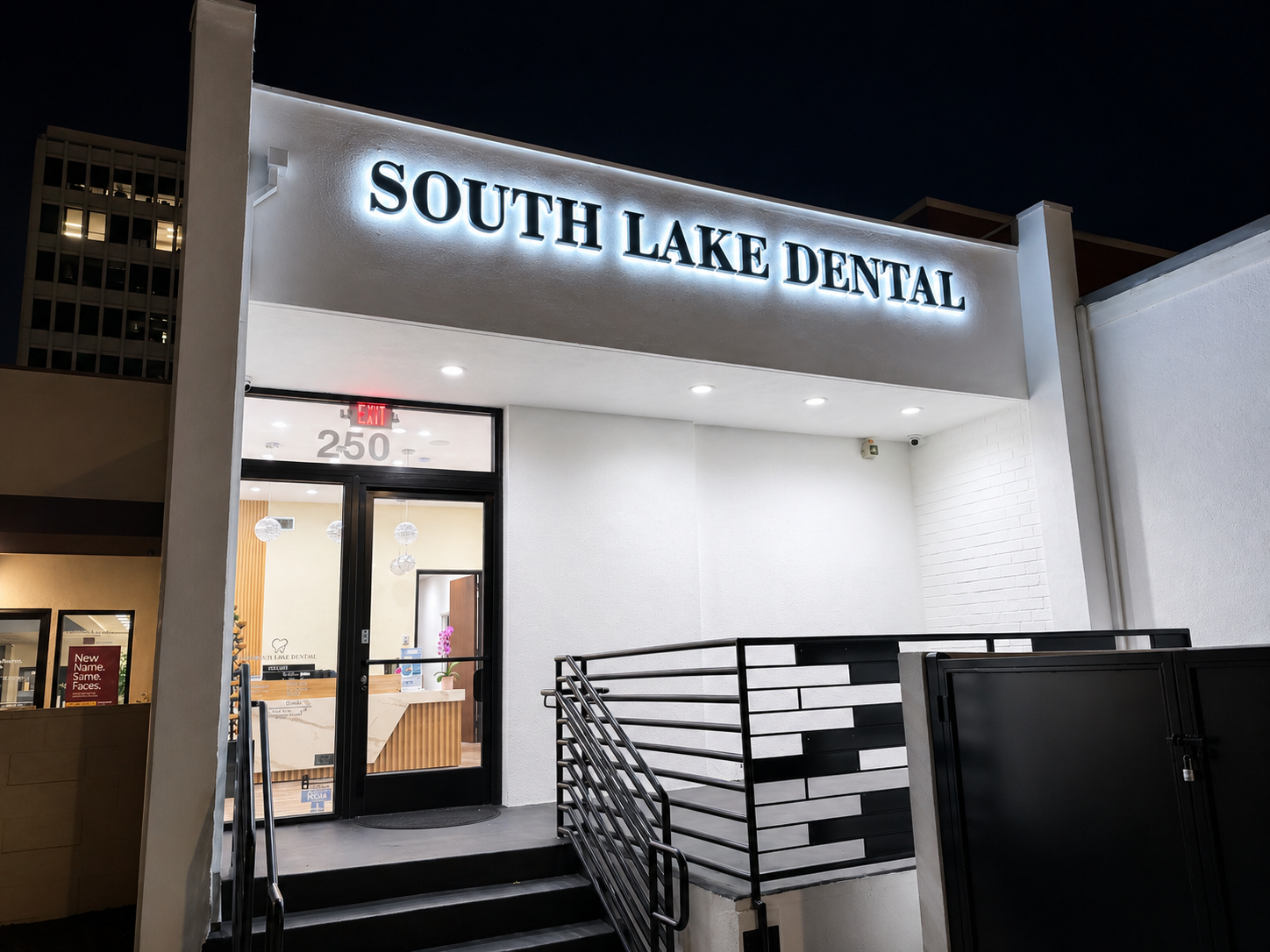 South Lake Dental storefront at night with lit sign and entrance.