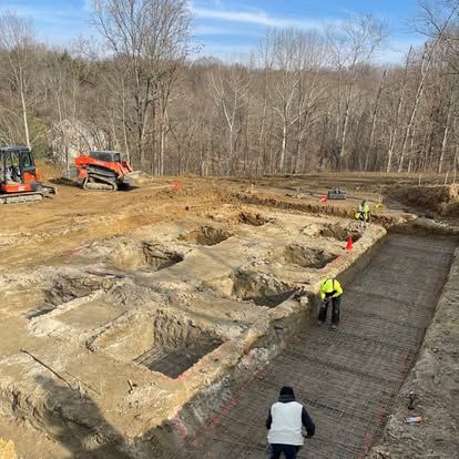 Foundation and footing excavation with trenches and reinforcing steel by Elevated Excavation