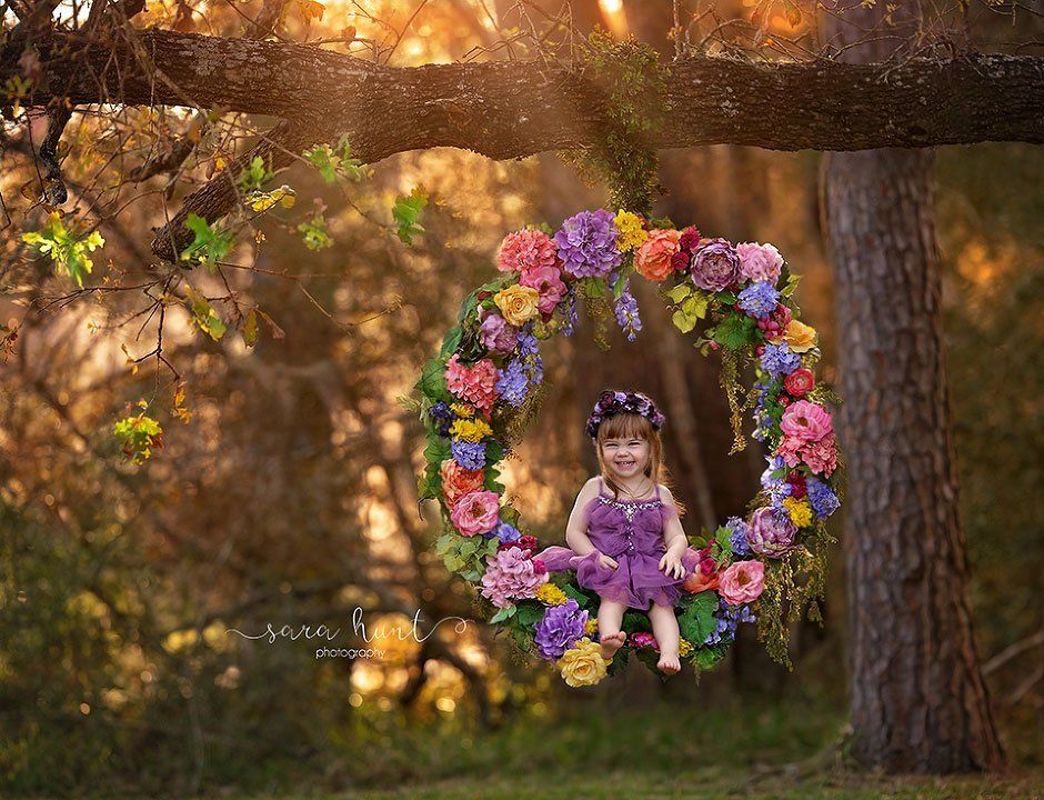 Cute girl laughing while sitting on a flower swing — Pearland, TX — Sara Hunt Photography