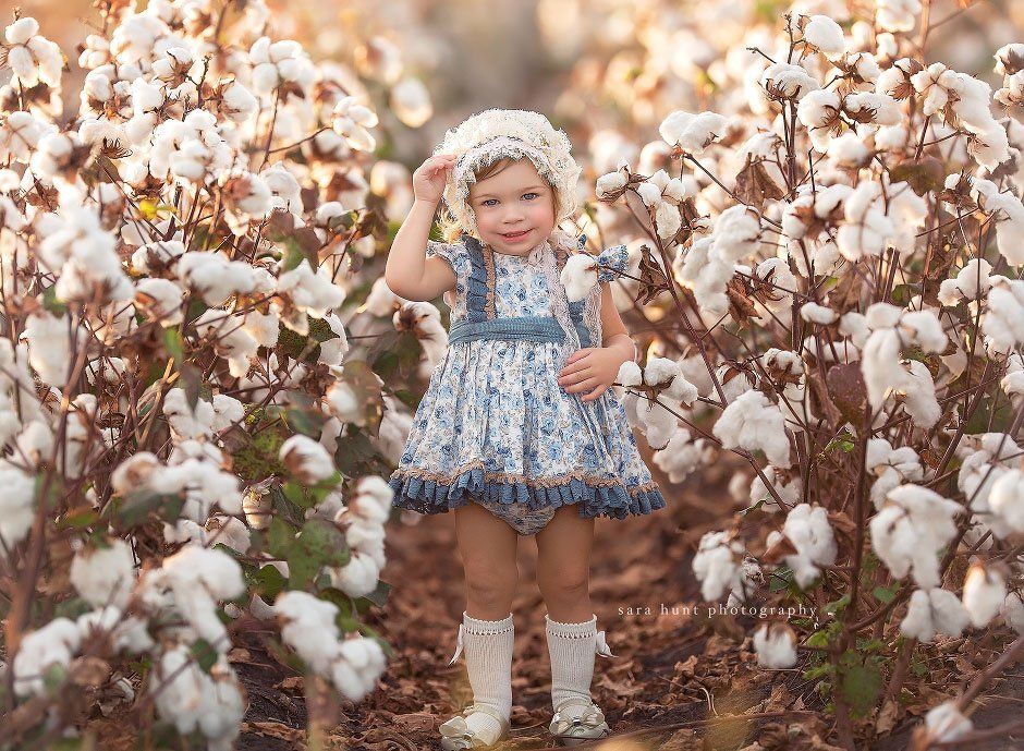Young girl holding her hat — Pearland, TX — Sara Hunt Photography