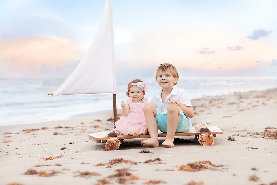 Siblings sitting on a wooden boat — Pearland, TX — Sara Hunt Photography