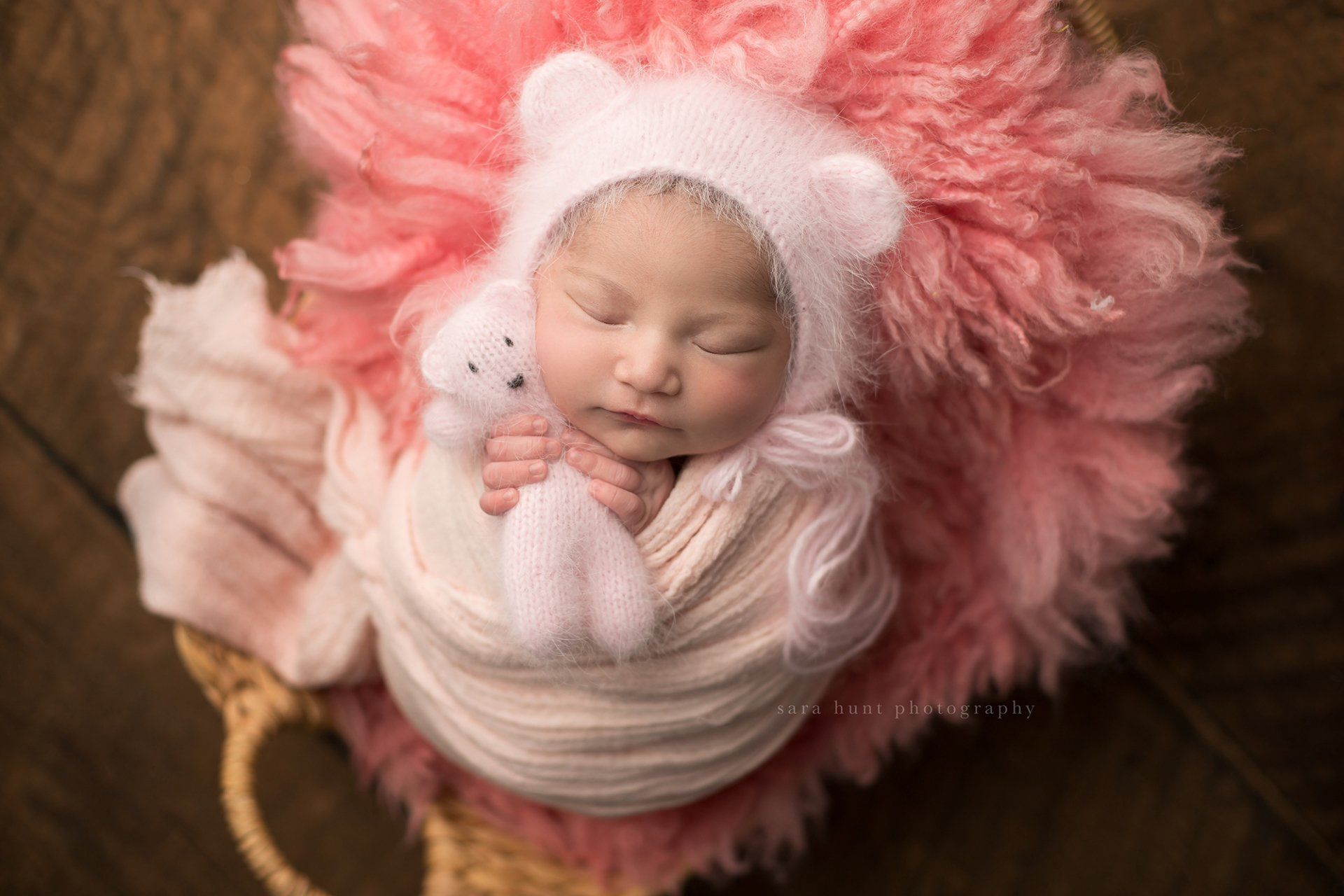 Baby wrapped while holding a pink bear — Pearland, TX — Sara Hunt Photography