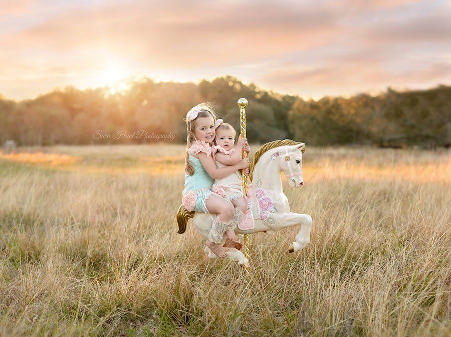 Two girls riding a carousel horse — Pearland, TX — Sara Hunt Photography