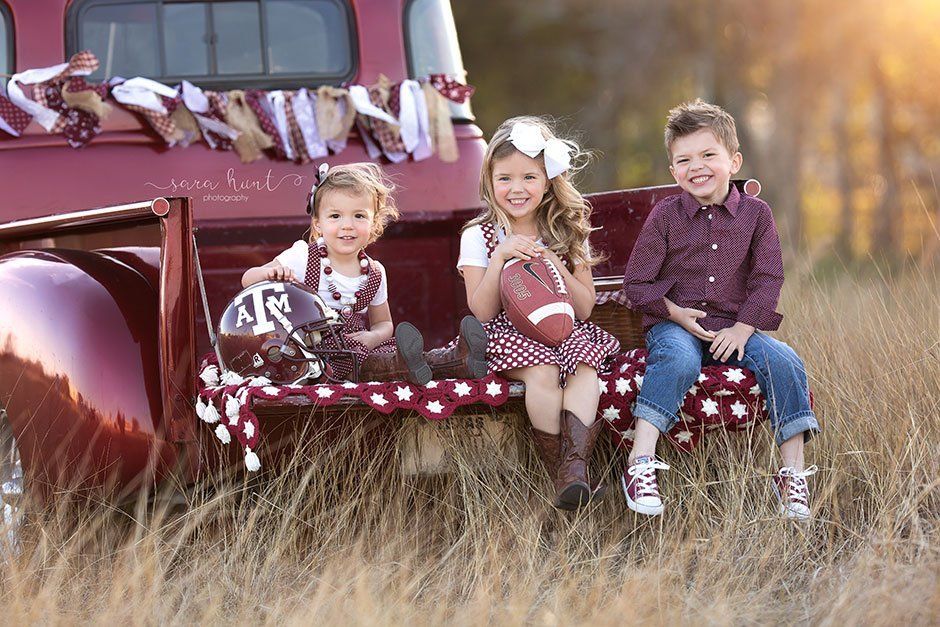 Sibling with football equipment — Pearland, TX — Sara Hunt Photography